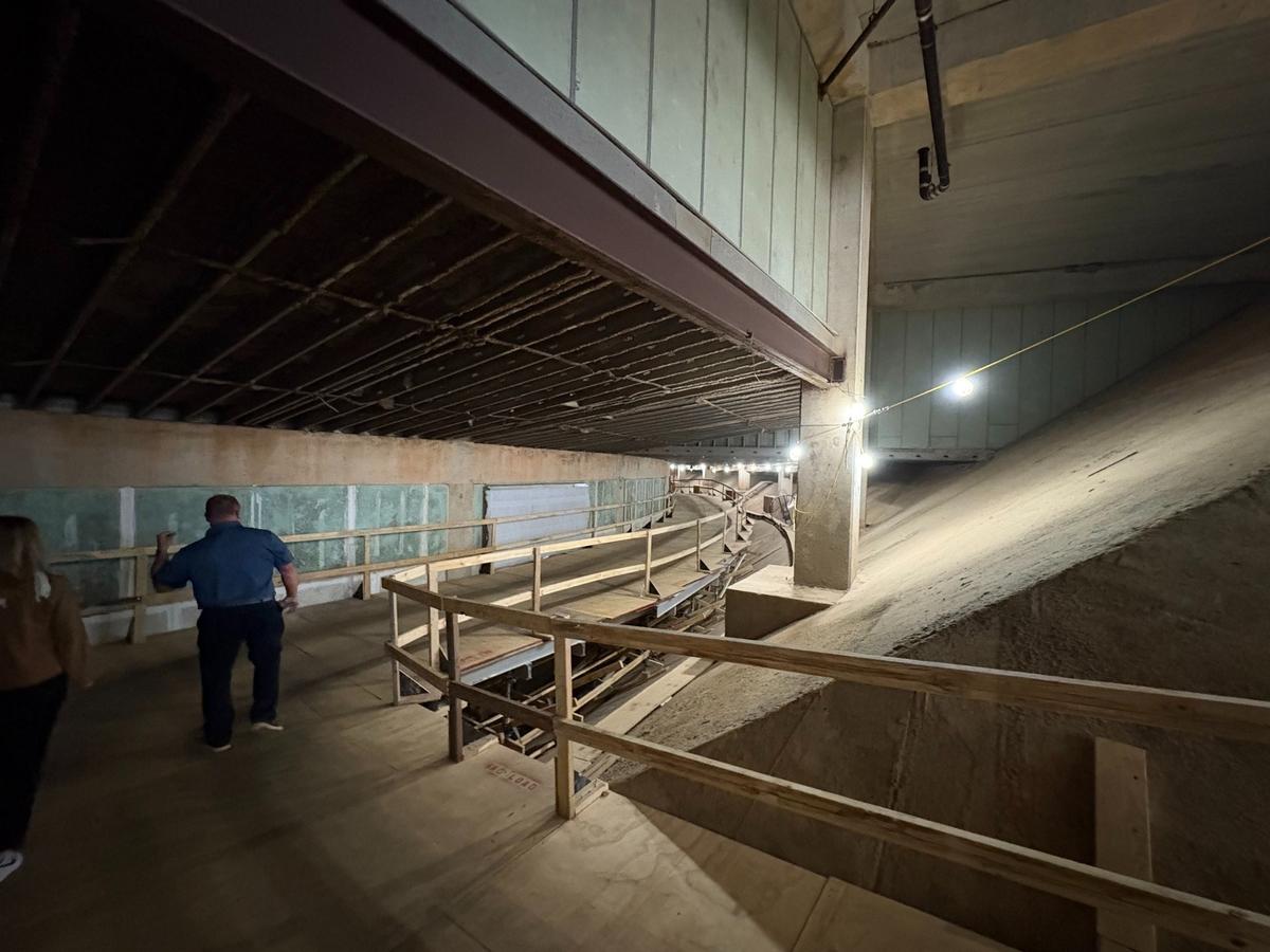 Hundreds of feet of scaffolding inside Lenovo Center allows contractors to move concrete and dirt out and pump new concrete in without disturbing arena events. As part of $300 million in renovations to the arena, contractors are carving out new space for mechanical equipment under the arena.