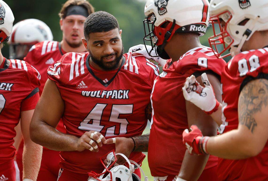 N.C. State defensive tackle Davin Vann (45) talks with defensive end Savion Jackson (9) during the Wolfpack’s first fall practice in Raleigh, N.C., Wednesday, August 2, 2023.