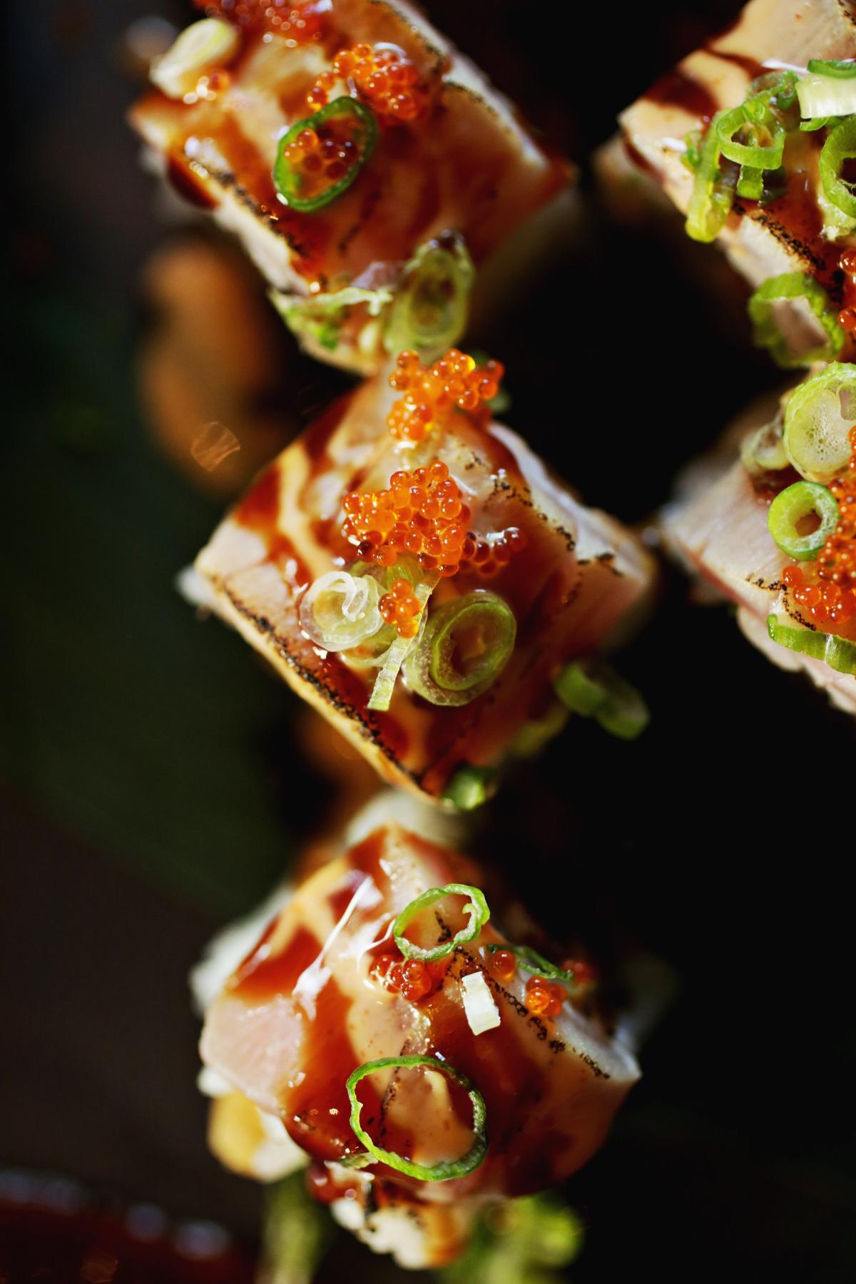 Fusion Fish’s 007 rolls are made up of spicy tuna and shrimp tempura and are topped with seared tuna, special sauce, sweet glaze, masago and scallions.