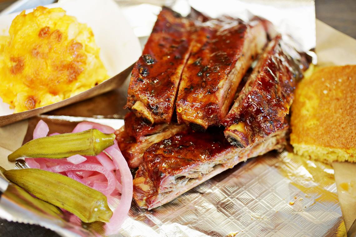 Redneck BBQ Lab’s St. Louis ribs are served here with cornbread, pickles and a side of jalapeno mac n cheese.