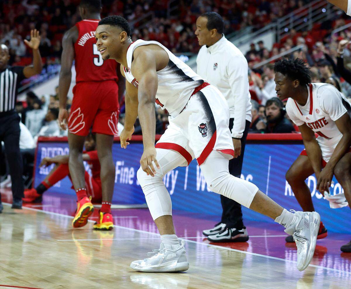N.C. State’s Casey Morsell (14) heads back downcourt after hitting a three-pointer during the second half of N.C. State’s 76-64 victory over Louisville at PNC Arena in Raleigh, N.C., Thursday, Dec. 22, 2022.