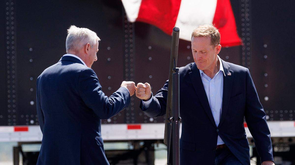 Michael Whatley, chair of the Republican National Committee, fist bumps U.S. Sen. Ted Budd during a Trump rally in Wilmington on Sept. 21, 2024. 