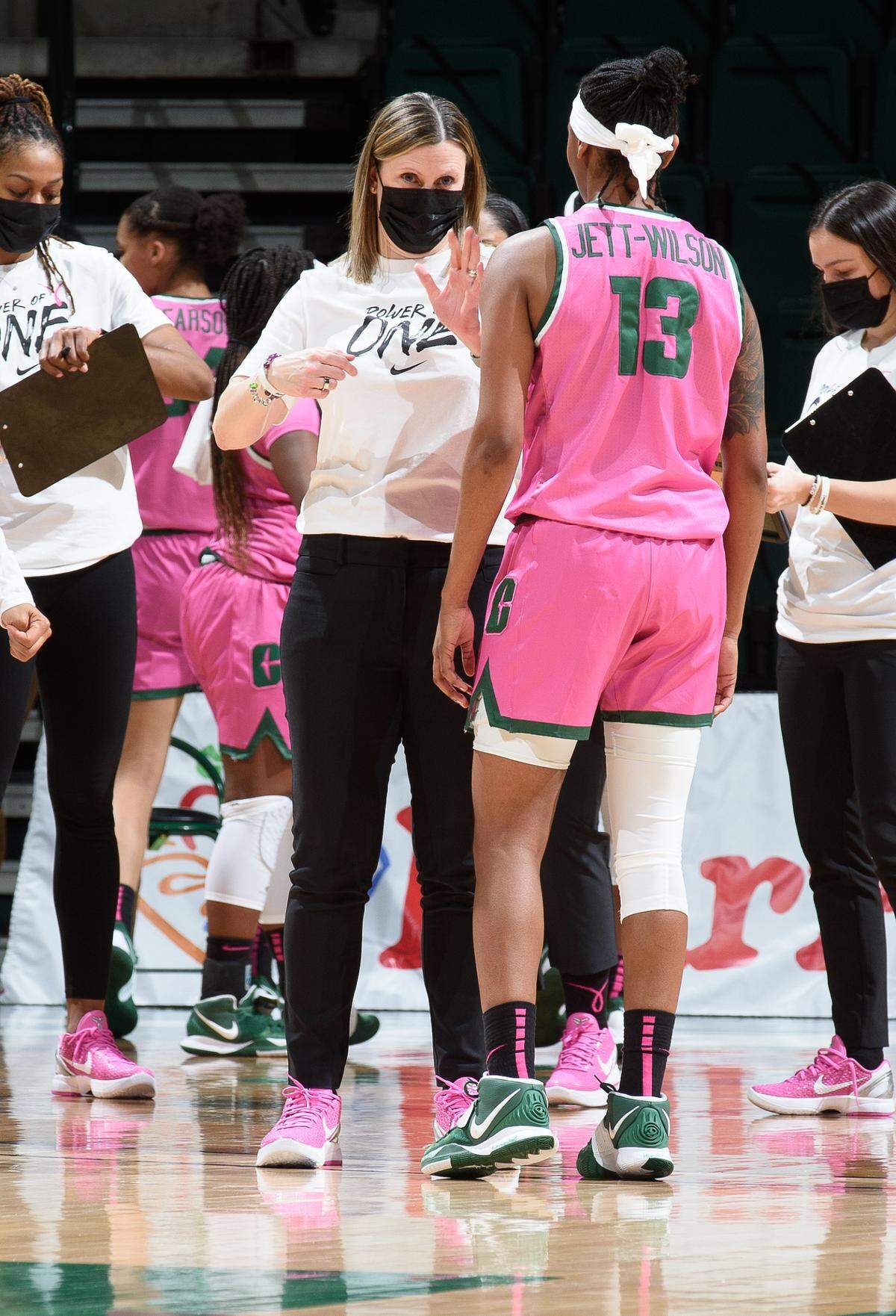 Cara Consuegra speaks to Octavia Jett-Wilson during a game in 2018.