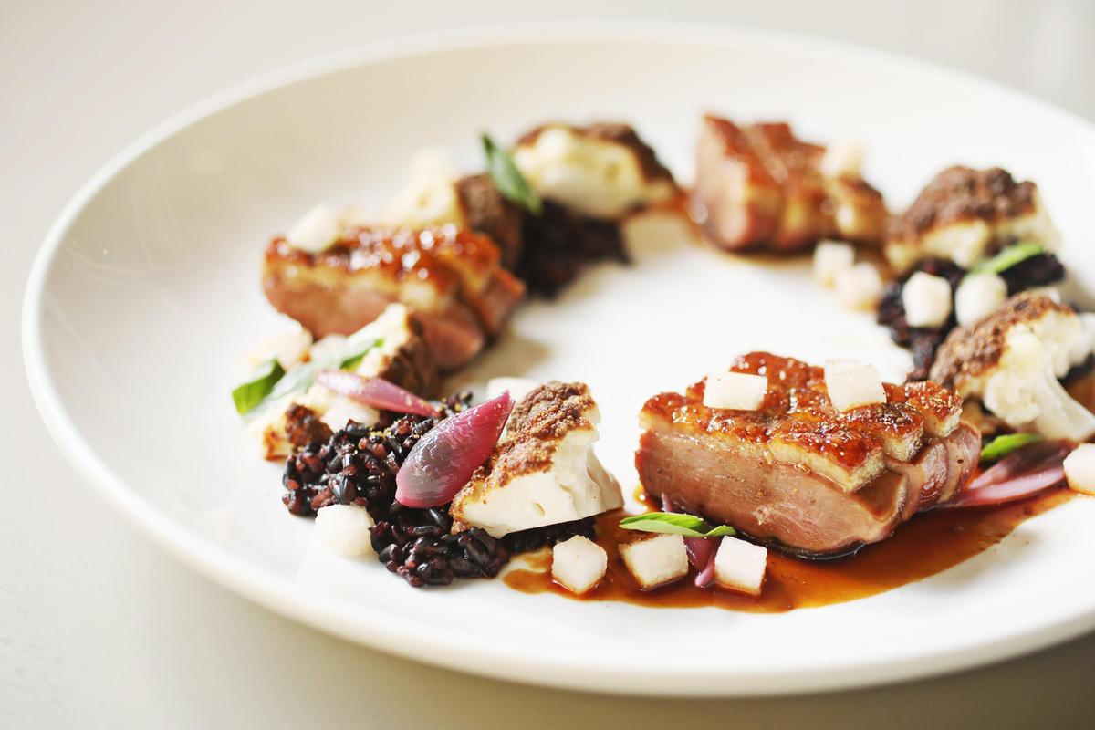 Hawthorne & Wood’s pan-roasted duck breast with a palm sugar glaze is served with forbidden rice, cauliflower and Hosui Asian pear.