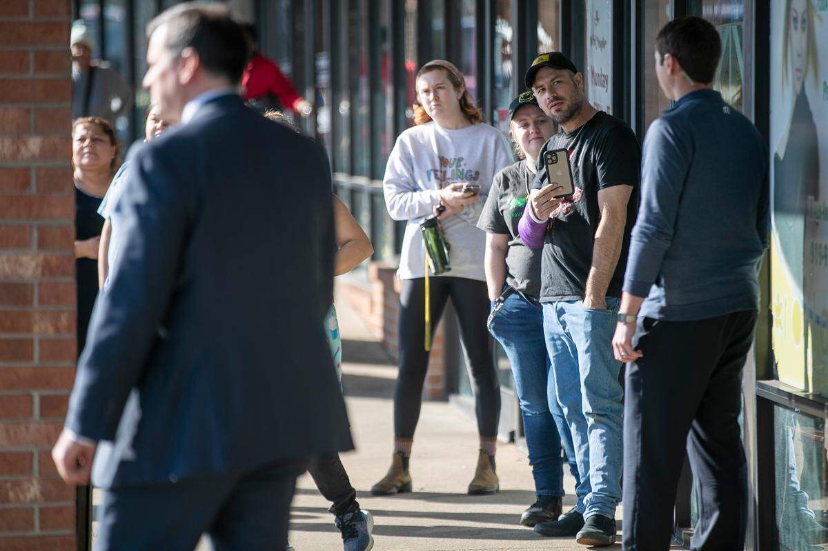 People wait to catch a glimpse of Vice President Kamala Harris during her visit to the Panaderia Artisanal bakery on Monday, January 30, 2023 in Raleigh, N.C.