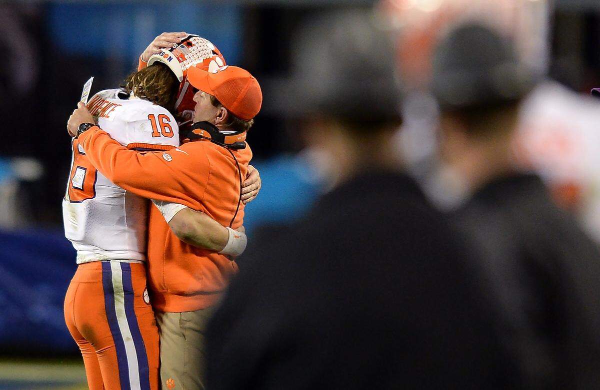 Clemson Tigers head coach Dabo Swinney, right, hugs quarterback Trevor Lawrence, left, after he left the ACC Championship during late fourth quarter action. Clemson defeated Notre Dame 34-10 to win the championship at Bank of America Stadium in Charlotte, NC on Saturday, December 19, 2020.  