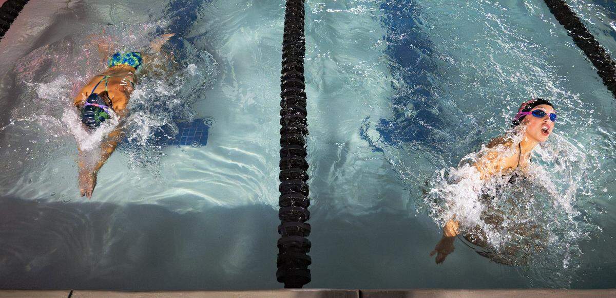 A swimmer for the Scottish Hill’s Sea Lions races to catch up to Cary Park Sea Dragon, Elle VanderWall, during the fifty meter breaststroke during a swim meet at Cary Park on June 25, 2024.