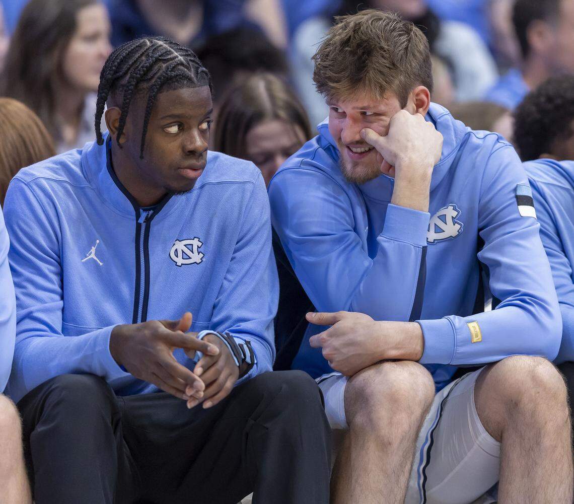 North Carolina leading scorers Caleb Wilson (8) and Henri Veesaar (13) chat on the bench during the second half against Pitt on Saturday, February 14, 2026 at the Smith Center in Chapel Hill, N.C. Neither played, Wilson is recovering from a fractured left hand, and Veesaar is recovering from illness and an injury. 