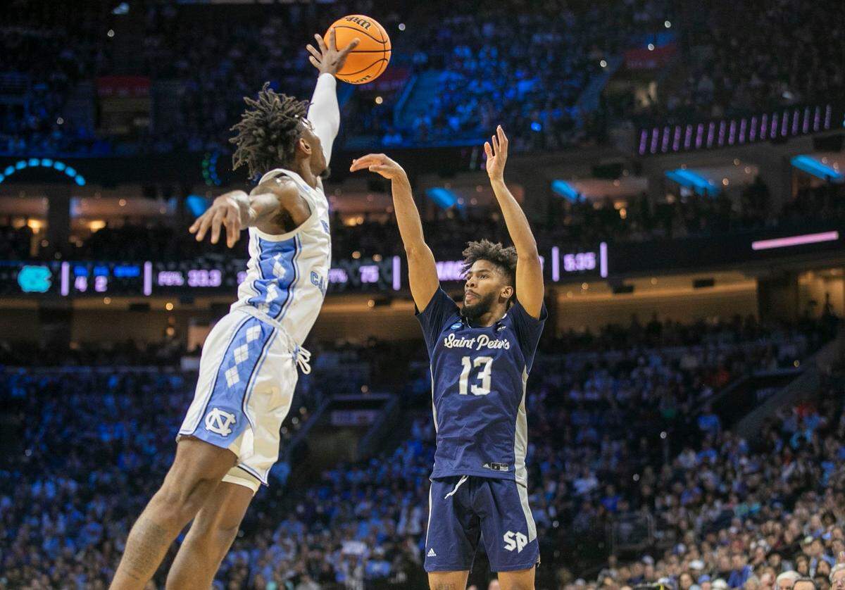 North Carolina’s Leaky Black (1) blocks a shot by Saint Peters Isiah Dasher (13) in the first half during the NCAA East Regional final on Sunday, March 27, 2022 at Wells Fargo Center in Philadelphia, Pa.