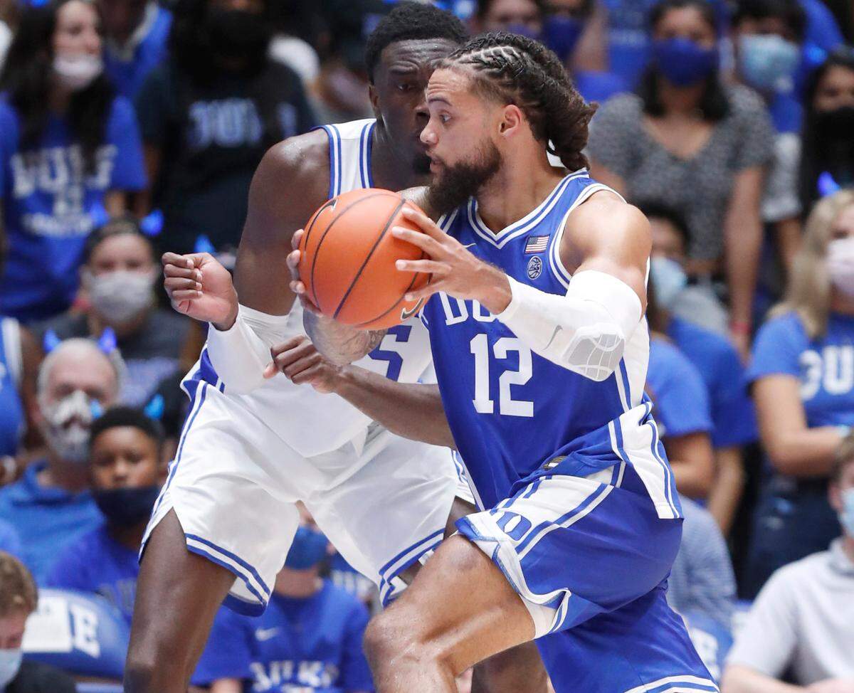 Duke’s Theo John (12) drives around Mark Williams (15) during a scrimmage during Countdown to Craziness at Cameron Indoor Stadium in Durham, N.C., Friday, October 15, 2021.