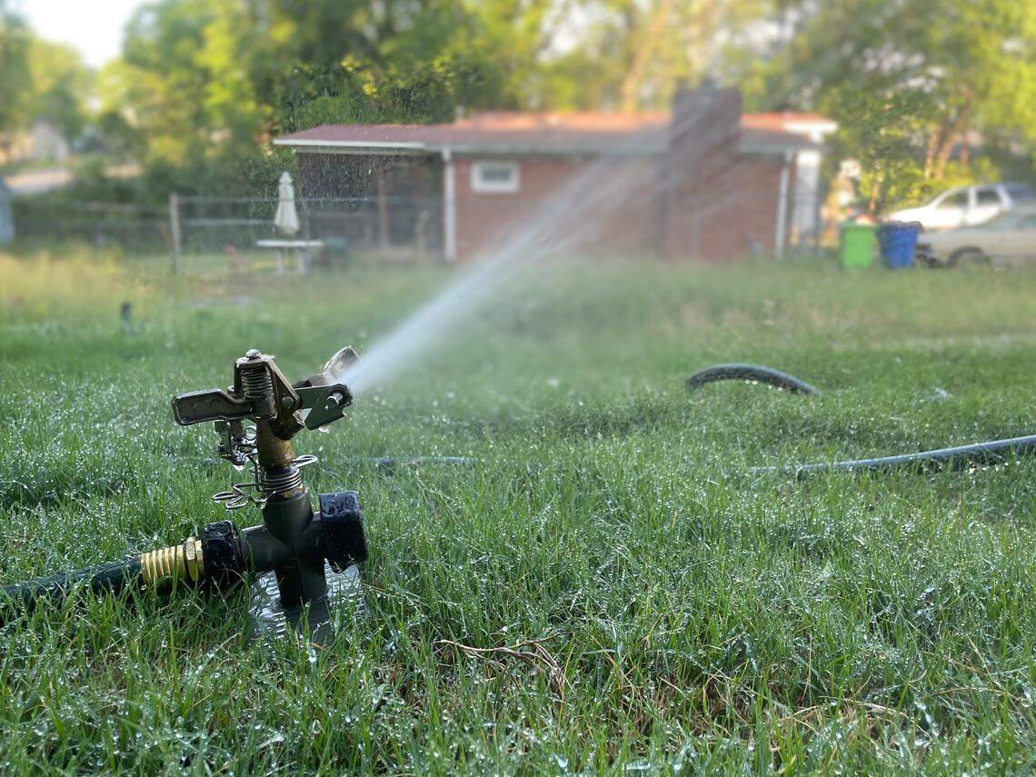 At a new home constructed on Bragg Street, the newly installed sod is watered in the afternoon sun on Thursday, April 16, 2026 in Raleigh, N.C. The City of Raleigh will institute new water restrictions on Monday April 20, 2026, as the region enters a severe drought.