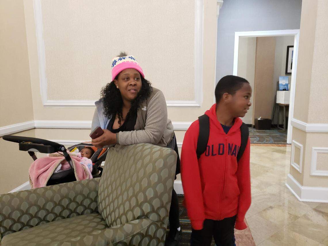 Samanther Crowder and her son Cody Hayes, 9, stand in the lobby of the Millennium Hotel waiting  for Cody’s school bus on Monday, Jan. 27, 2020 
