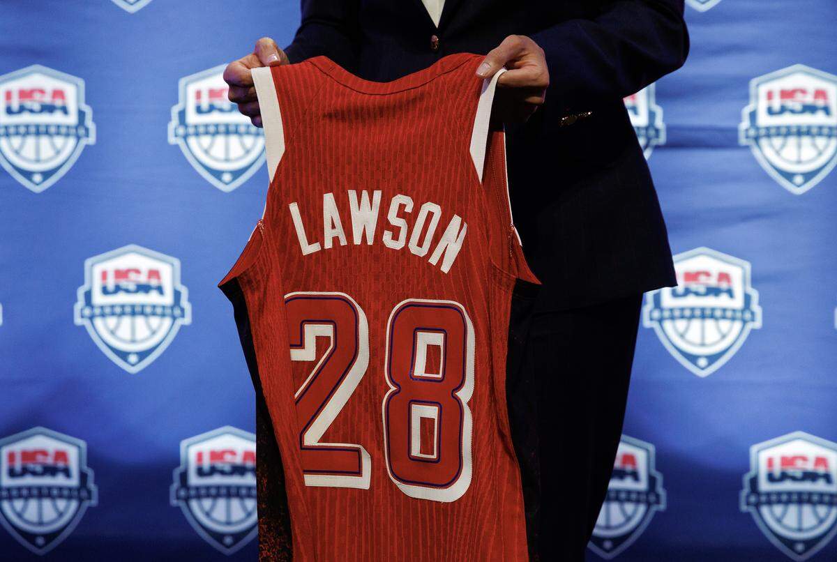 Duke women’s basketball head coach Kara Lawson holds a jersey after being named the 2025-2028 USA Basketball Women’s National Team head coach during a ceremony at Cameron Indoor Stadium on Tuesday, Sept. 23, 2025, in Durham, N.C.