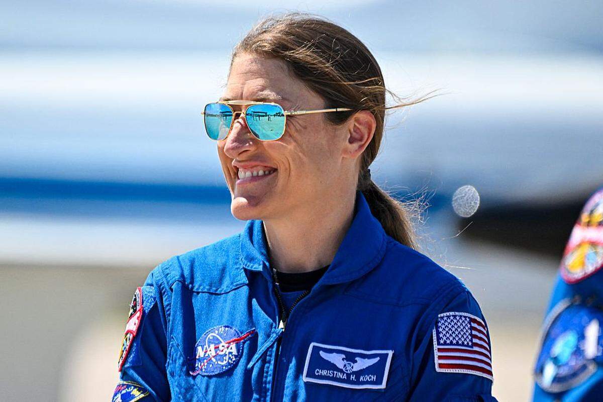 NASA astronaut and Artemis II Mission Specialist Christina Koch looks on during a welcome ceremony ahead of the Artemis II April 1 launch at Kennedy Space Center in Florida on March 27, 2026. NASA and Canadian Space Agency astronauts assigned to the Artemis II mission arrive at Kennedy Space Center in Florida on March 27, 2026, to begin final pre-launch preparations for the first crewed lunar flyby in the Artemis program. The journey, set to last around 10 days, will take the astronauts on a loop around the Moon, though they will not land on its surface. The crew comprises the first woman, the first person of color and the first non-American to take part in such a journey. (Photo by Miguel J Rodriguez Carrillo / AFP via Getty Images)