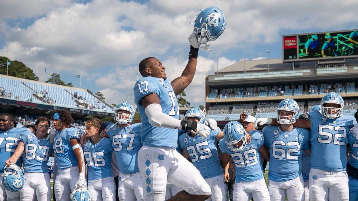 North Carolina’s Chris Collins (17) and his teammate celebrate the Tar Heels’ 38-7 victory over Duke on Saturday, October 2, 2021 at Kenan Stadium in Chapel Hill, N.C.