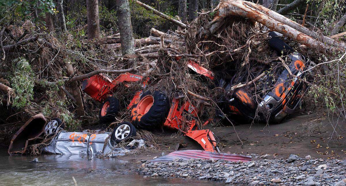 Vehicles and machinery sit underneath debris near the North Toe River in Avery County on Tuesday, Oct. 1, 2024, days after Hurricane Helene brought heavy rain and flooding to the North Carolina mountains.