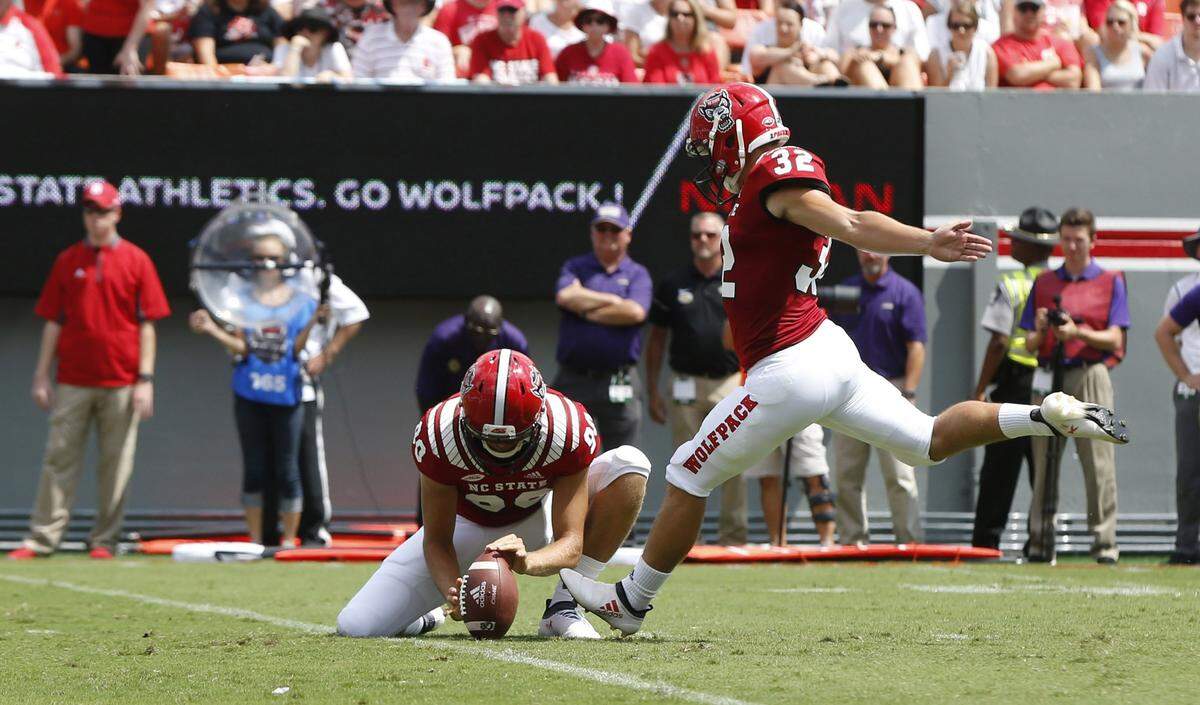 N.C. State’s Christopher Dunn (32) kicks a 25-yard field goal as A.J. Cole III holds the ball during the first half of N.C. State’s game against James Madison at Carter-Finley Stadium in Raleigh, N.C., Saturday, Sept. 1, 2018.