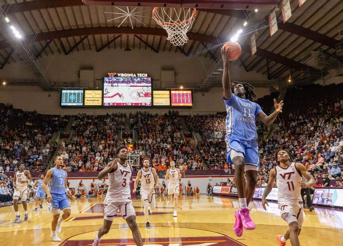 North Carolina guard Ian Jackson (11) breaks to the basket against Virginia Tech’s Jaydon Young (3) in the first half on Tuesday, March 3, 2025 at Cassell Coliseum in Blacksburg, Va. Jackson led all scores with 19 points in the Tar Heels’ 91-59 victory.