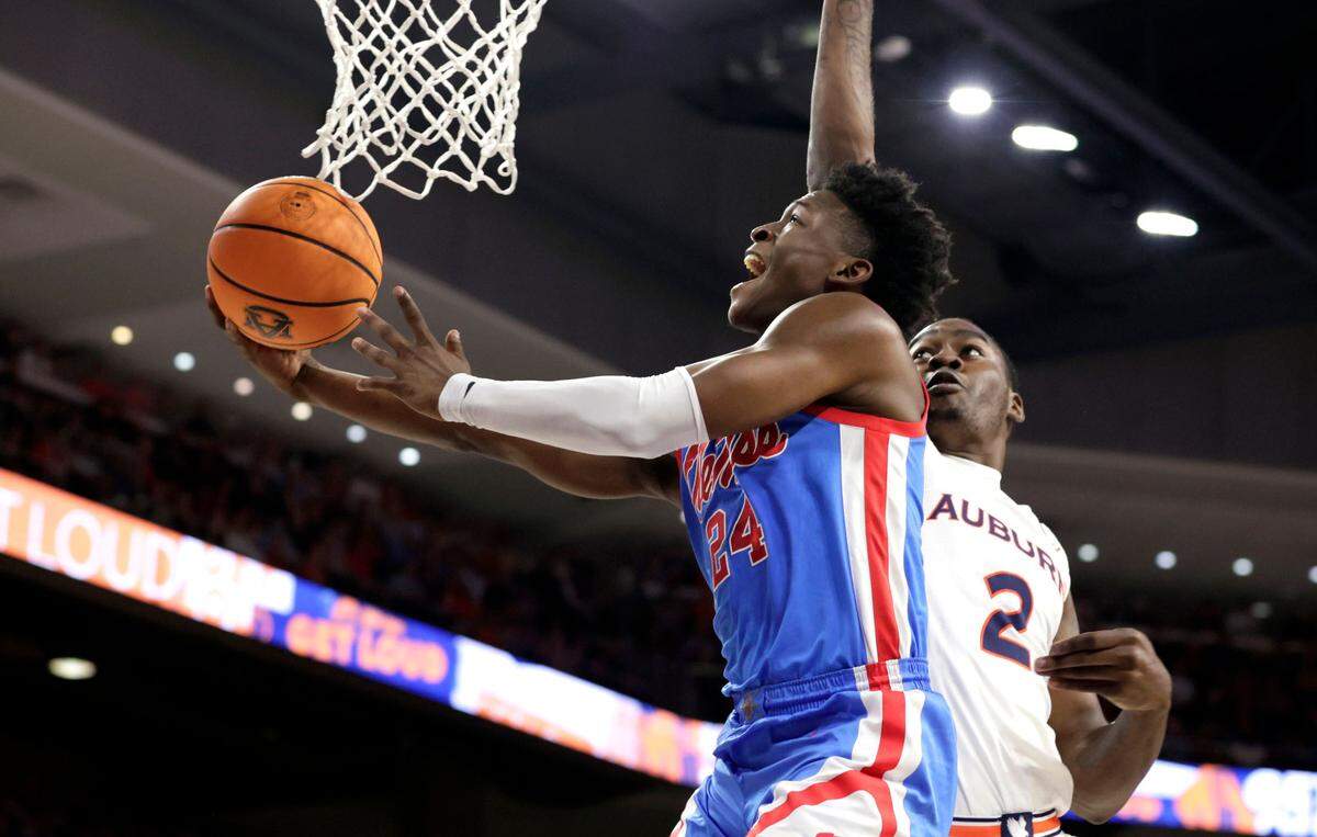 Mississippi guard Jarkel Joiner (24) is fouled by Auburn forward Jaylin Williams (2) as he goes up for a lay up during the first half of an NCAA college basketball game Wednesday, Feb. 23, 2022, in Auburn, Ala.