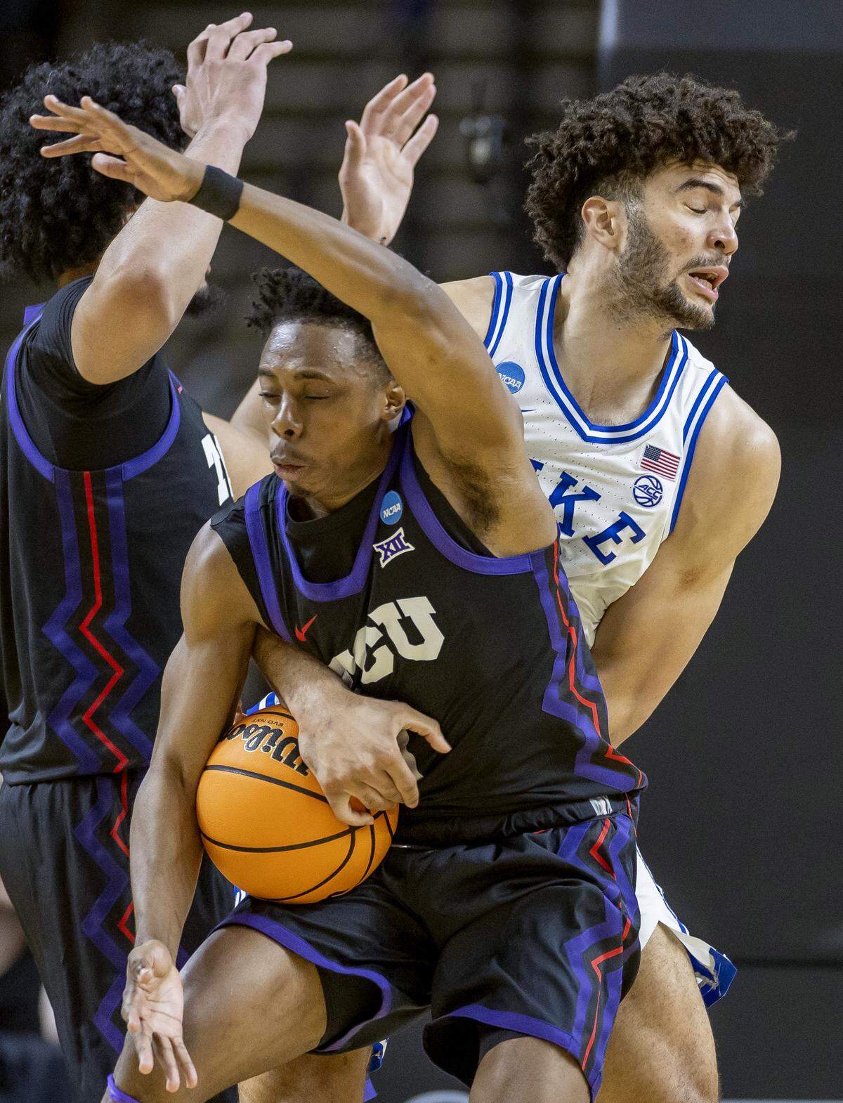 Duke forward Cameron Boozer (12) gets tangled with TCU guard Jayden Pierre (1) in the second half on Saturday, March 21, 2026, during the second round of the NCAA Tournament at Bon Secours Arena in Greenville, S.C.