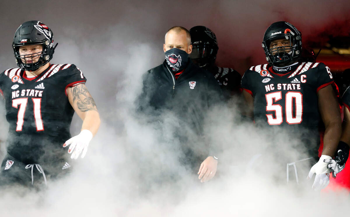N.C. State head coach Dave Doeren leads his team onto the field before N.C. State’s game against Miami at Carter-Finley Stadium in Raleigh, N.C., Friday, Nov. 6, 2020.