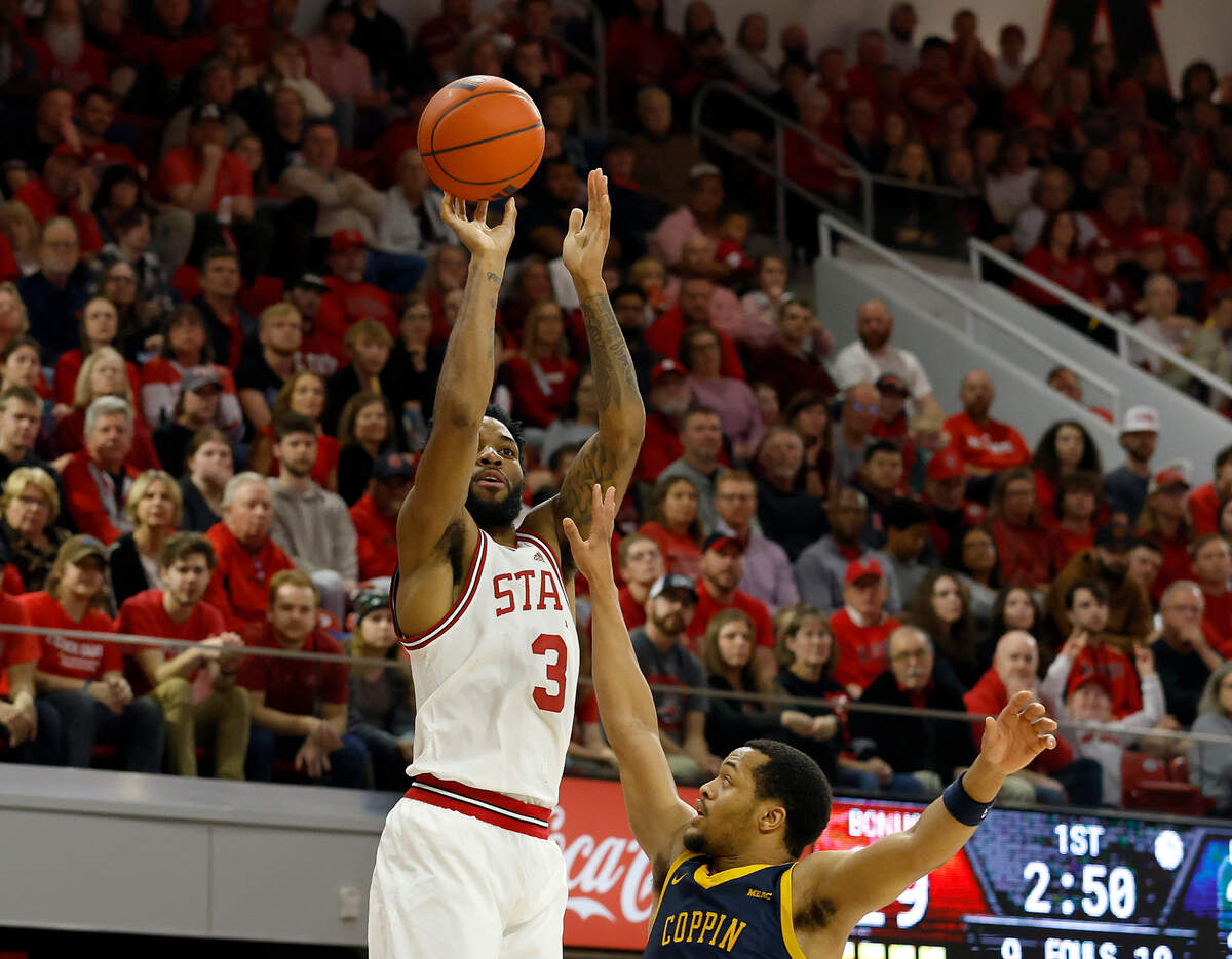 N.C. State’s Dontrez Styles shoots over Coppin State’s Cam’Ron Brown during the first half of the Wolfpack’s 66-56 win on Tuesday, Dec. 10, 2024, at Reynolds Coliseum in Raleigh, N.C.