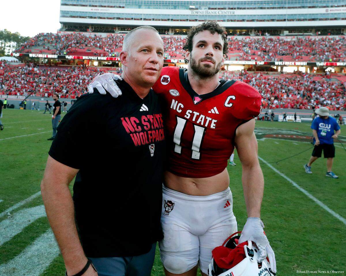 N.C. State head coach Dave Doeren and linebacker Payton Wilson walk off the field after the Wolfpack’s 24-17 victory over Clemson at Carter-Finley Stadium in Raleigh, N.C., Saturday, Oct. 28, 2023.