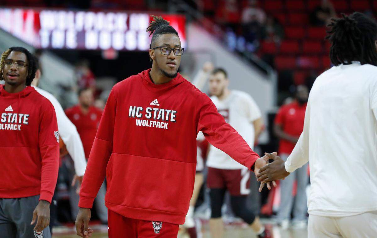 N.C. State’s Manny Bates (15) encourages Jaylon Gibson (11) before N.C. State’s game against Colgate at PNC Arena in Raleigh, N.C., Saturday, November 13, 2021.