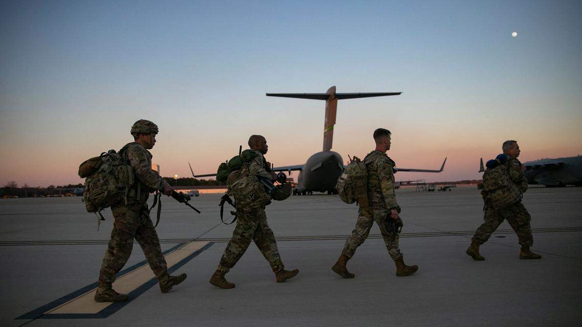 Soldiers of the 82nd Airborne Division walk to board a plane from Pope Army Airfield in Fort Bragg, North Carolina on February 14, 2021 as they are deployed to Europe. - US service members based in Fort Bragg, North Carolina, are preparing deploy to Europe as the crisis between Russia and Ukraine escalates. (Photo by Allison Joyce / AFP) (Photo by ALLISON JOYCE/AFP via Getty Images)