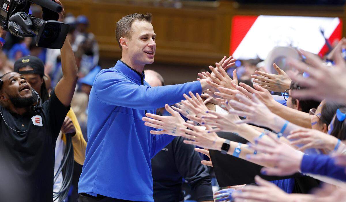 Duke head coach Jon Scheyer greets the fans after Duke’s 63-57 victory over UNC at Cameron Indoor Stadium in Durham, N.C., Saturday, Feb. 4, 2023.