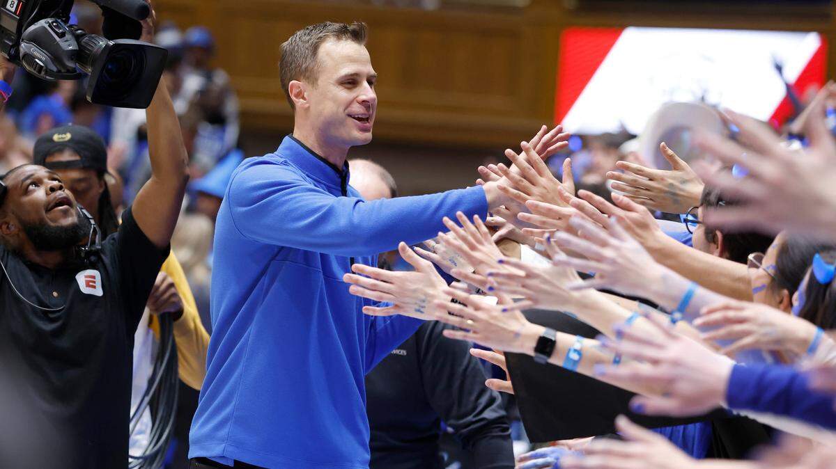 Duke head coach Jon Scheyer greets the fans after Duke’s 63-57 victory over UNC at Cameron Indoor Stadium in Durham, N.C., Saturday, Feb. 4, 2023.