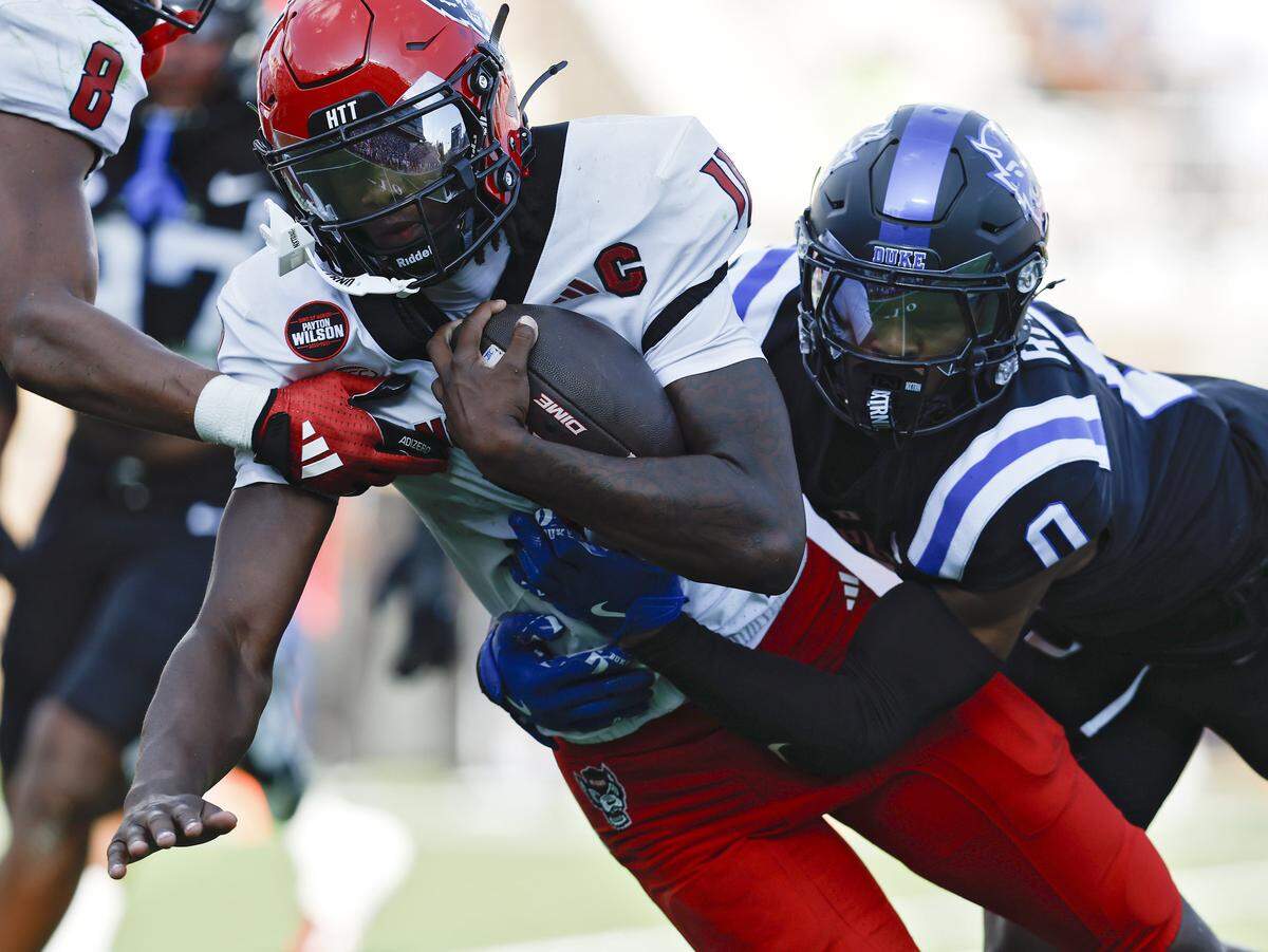 Duke’s Chandler Rivers tackles N.C. State quarterback CJ Bailey during the first half of the Blue Devils’ game on Saturday, Sept. 20, 2025, at Wallace Wade Stadium in Durham, N.C.