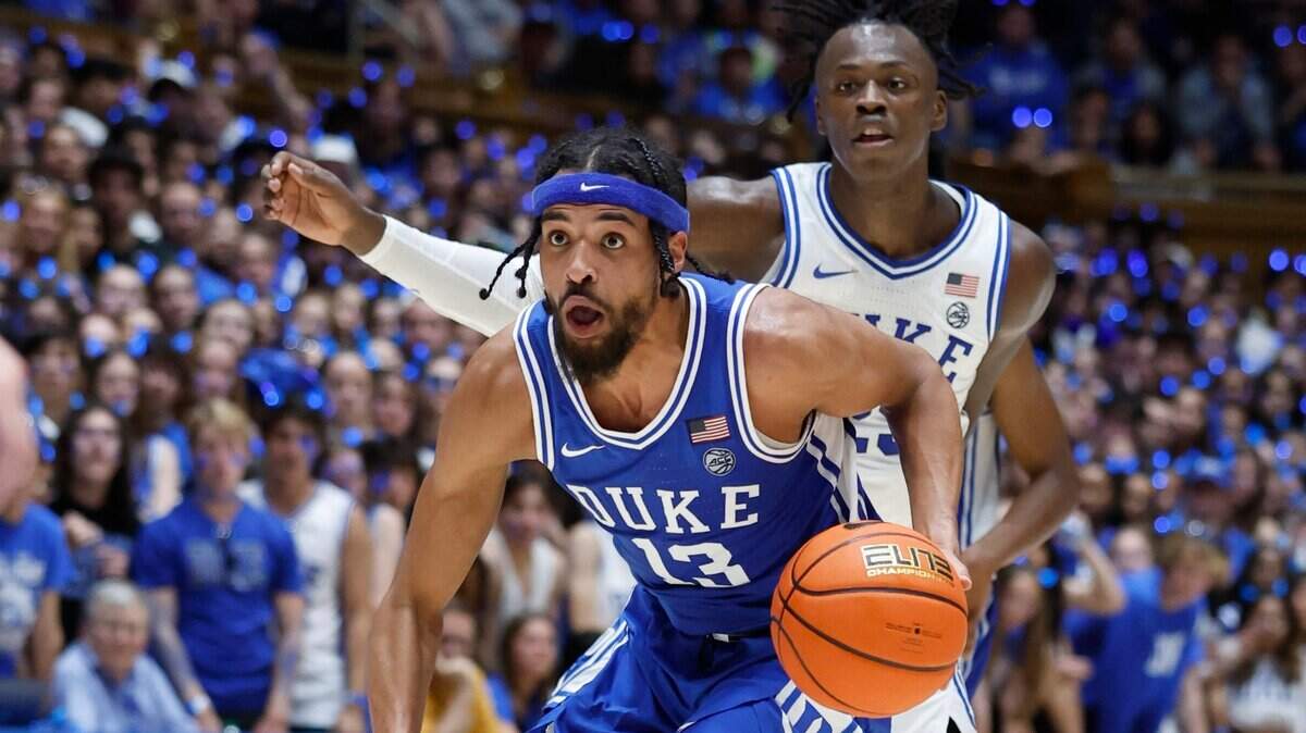 Duke’s Jacob Grandison (13) drives by Mark Mitchell (25) during the Blue-White scrimmage during Duke’s Countdown to Craziness at Cameron Indoor Stadium in Durham, N.C., Friday, Oct. 21, 2022.