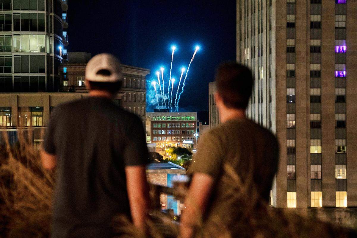 Fireworks for the Durham Bulls Game explode behind the roof of The Durham in downtown on Saturday, June 18, 2022.