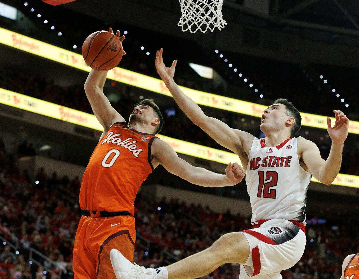 Virginia Tech’s Hunter Cattoor grabs a rebound away from N.C. State’s Michael O’Connell during the second half of the Wolfpack’s 84-78 loss on Saturday, Jan. 20, 2024, at PNC Arena in Raleigh, N.C.