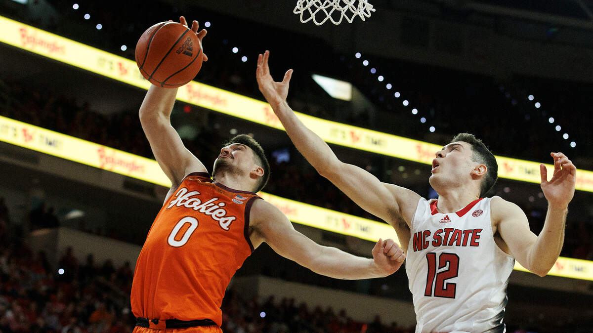 Virginia Tech’s Hunter Cattoor grabs a rebound away from N.C. State’s Michael O’Connell during the second half of the Wolfpack’s 84-78 loss on Saturday, Jan. 20, 2024, at PNC Arena in Raleigh, N.C.