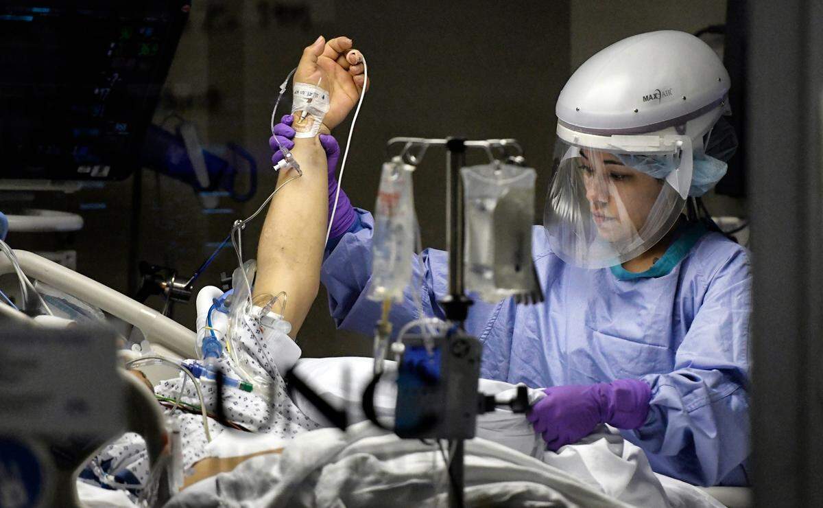 Registered nurse Kat Phillips cares for a Covid patient in the Medical Intensive Care Unit (MICU) at UNC Hospital in Chapel Hill on Thanksgiving Day, Thursday, Nov. 26, 2020.
