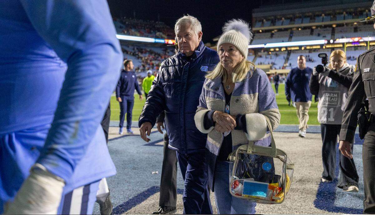 North Carolina coach Mack Brown and his wife Sally leave the field following the Tar Heels’ 35-30 loss to N.C. State on Saturday, November 30, 2024 at Kenan Stadium in Chapel Hill, N.C.
