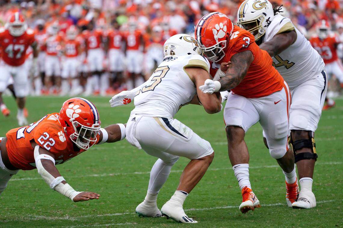 Georgia Tech quarterback Jordan Yates (13) is sacked by Clemson’s Trenton Simpson (22) and Xavier Thomas (3) in the second half of an NCAA college football game Saturday, Sept. 18, 2021, in Clemson, S.C.