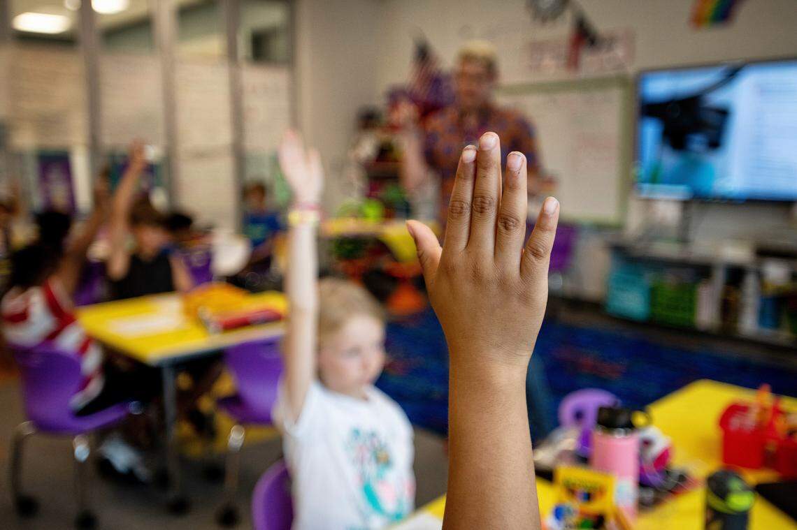 Third graders raise their hands to answer questions during a lesson on fractions in Tyler Ellzey’s class at Buckhorn Ridge Elementary in Holly Springs, N.C.
