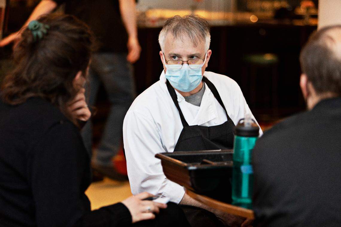 Chef Shane Ingram leans in to listen during a meeting with staff before service in the dining room at The Durham on Thursday, Feb. 24, 2022.