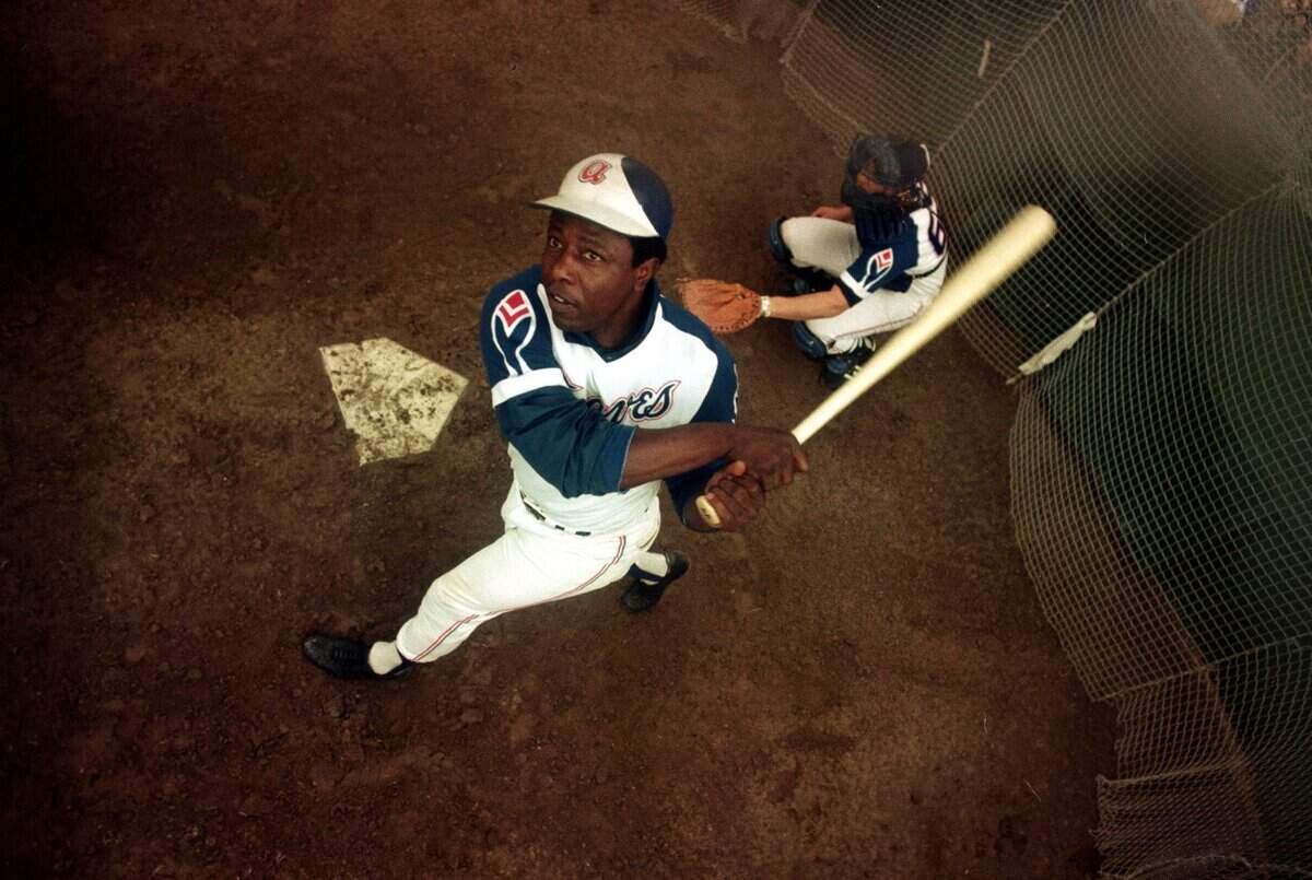 In this March 1974 file photo, Atlanta Braves outfielder Hank Aaron swings a bat at home plate during spring training. Hank Aaron, who endured racist threats with stoic dignity during his pursuit of Babe Ruth but went on to break the career home run record in the pre-steroids era, died early Friday, Jan. 22, 2021. He was 86. The Atlanta Braves said Aaron died peacefully in his sleep. No cause of death was given.