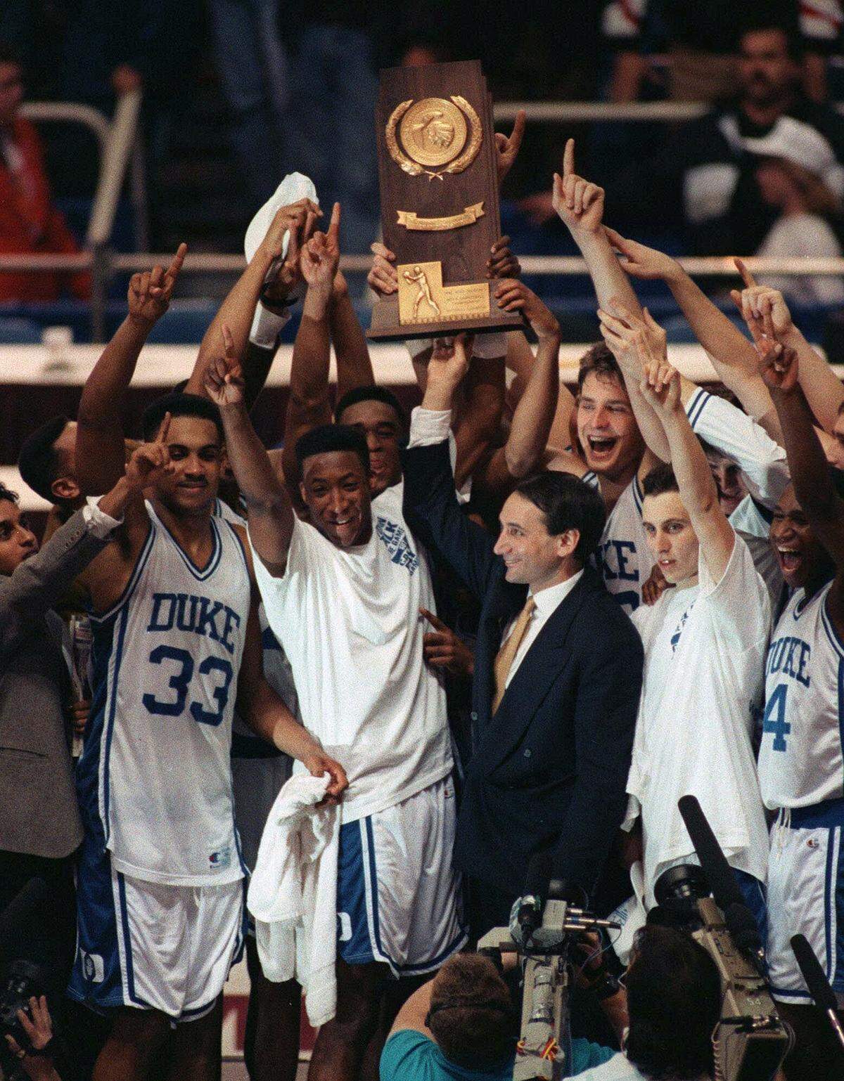Coach Mike Krzyzewski and his Duke team celebrate April 7, 1992 in Minneapolis, after receiving their championship trophy. Duke beat Michigan 71-51.