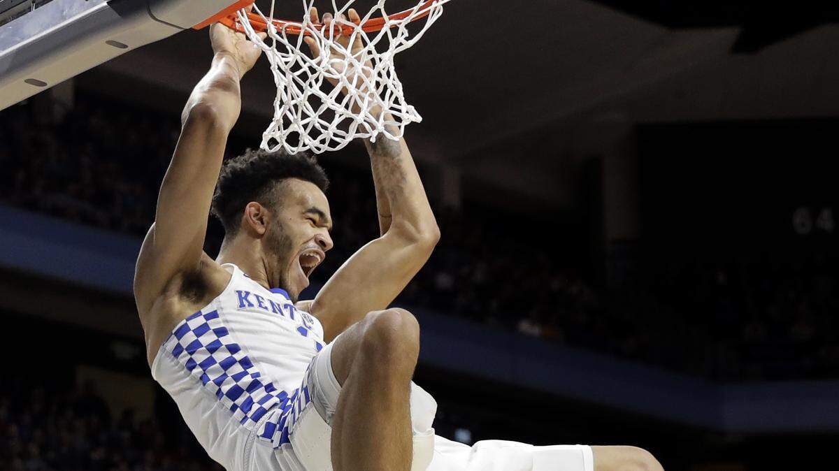 Kentucky forward Sacha Killeya-Jones hangs from the rim after a dunk against Davidson during the second half of a first-round game in the NCAA men's college basketball tournament Thursday, March 15, 2018, in Boise, Idaho. Kentucky won 78-73. (AP Photo/Otto Kitsinger)