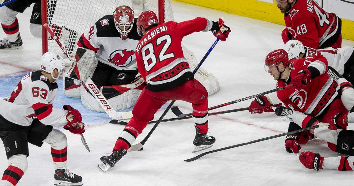 The Carolina Hurricanes Jesperi Kotkaniemi (82) scores the second of his goals on New Jersey Devils goalie Akira Schmid (40) in the second period during Game 2 of their second round Stanley Cup playoff series on Friday, May 5, 2023 at PNC Arena in Raleigh, N.C.