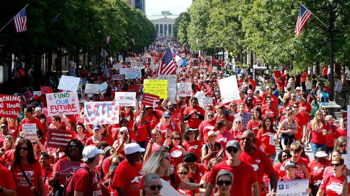 Thousands of teachers, other school employees and their supporters marched up Fayetteville Street through downtown Raleigh during a “Day of Action” organized by the N.C. Association of Educators Wednesday, May 1, 2019.