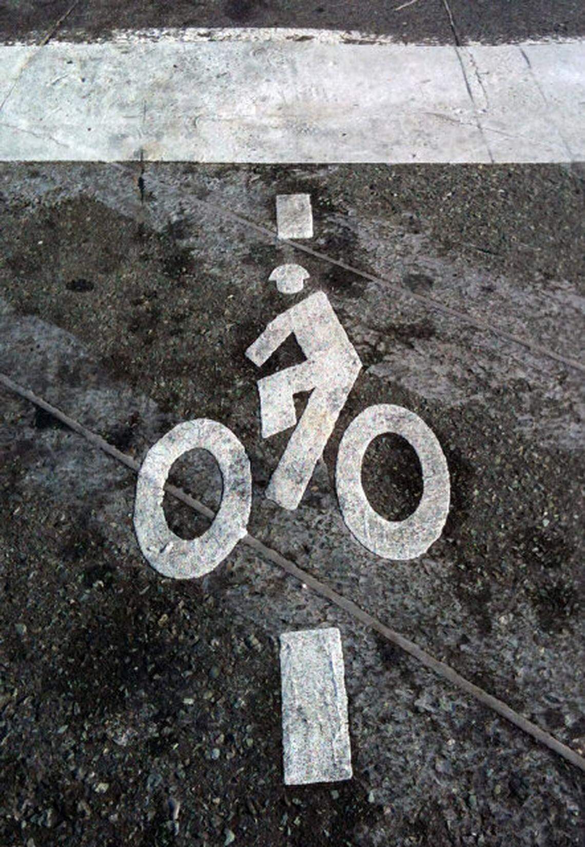 Some intersections around Chapel HIll and Carrboro are marked with smaller bike heiroglyphs to indicate where cyclists should stop for newly sensitive pavement loops that actually will tell the traffic signal that a two-wheeler is waiting for a green light.