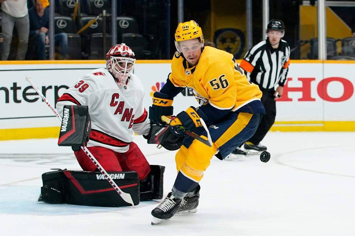 Nashville Predators defenseman Matt Benning (5) reaches for the puck after Carolina Hurricanes goaltender Alex Nedeljkovic (39) blocked a shot during the second period in Game 3 of an NHL hockey Stanley Cup first-round playoff series Friday, May 21, 2021, in Nashville, Tenn. (AP Photo/Mark Humphrey)