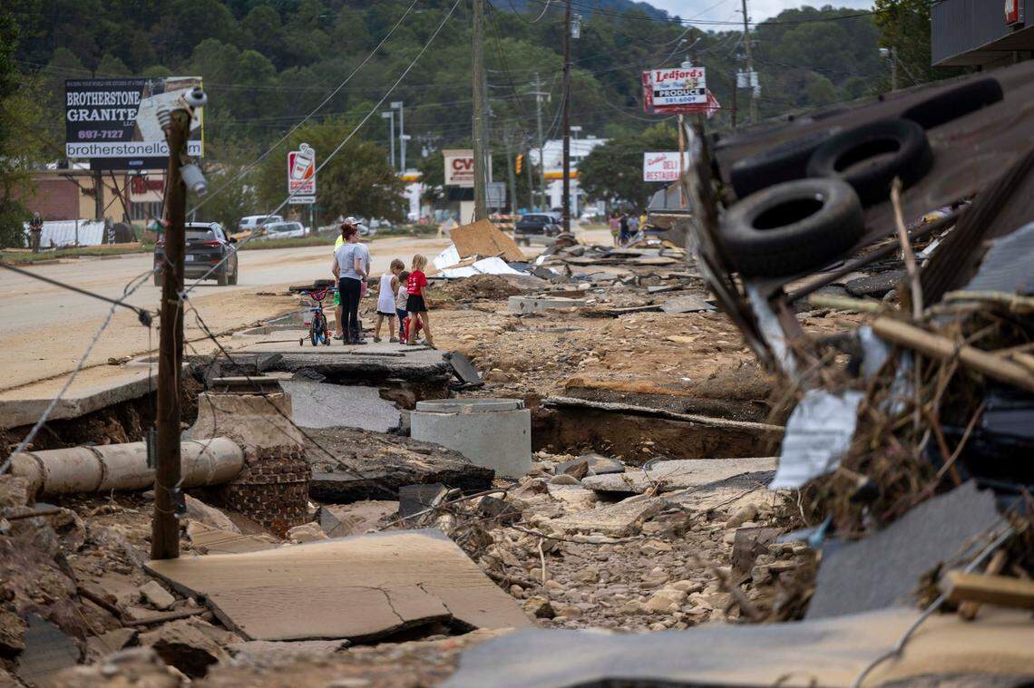 Swannanoa residents walk through devastating flood damage from the Swannanoa River on Sunday, Sept. 29, 2024. The remnants of Hurricane Helene caused widespread flooding, downed trees, and power outages in western North Carolina.