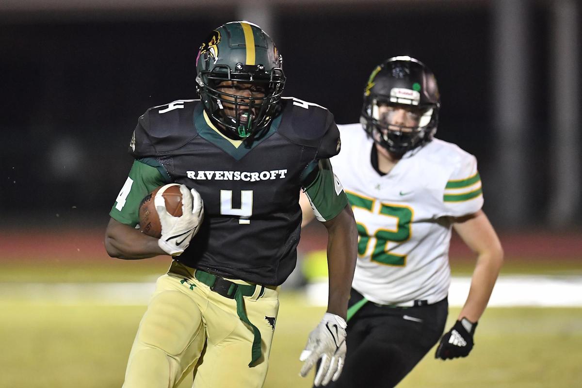 Ravenscroft wide receiver Joshua Bussey (4) runs for the first down ahead of Harrells Christian’s Coley Sasser (52) during the second half. The Ravenscroft Ravens and the Harrells Christian Crusaders met in a football game in Raleigh, N.C. on October 21, 2022.